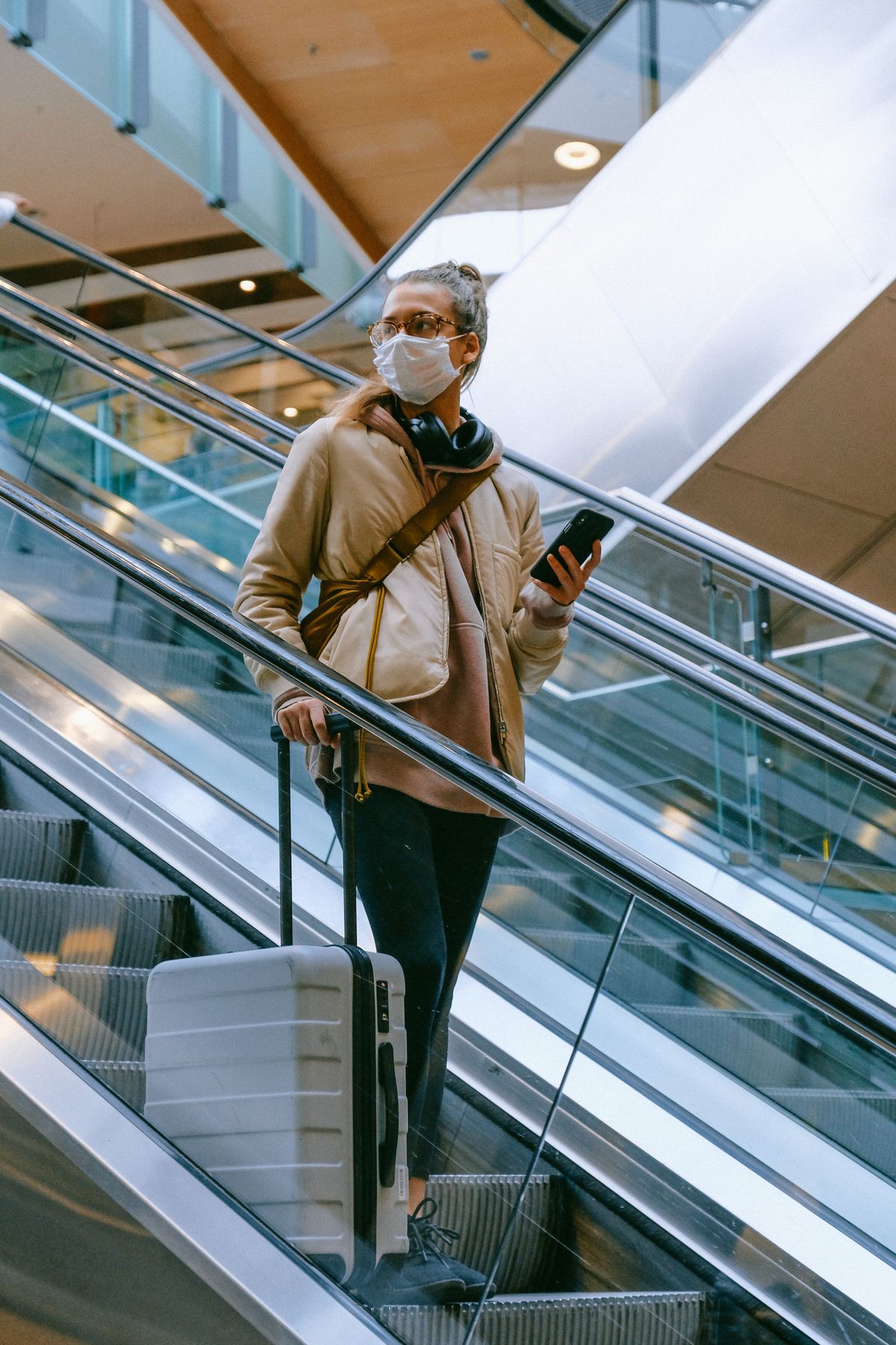 A traveller with a suitcase in an airport